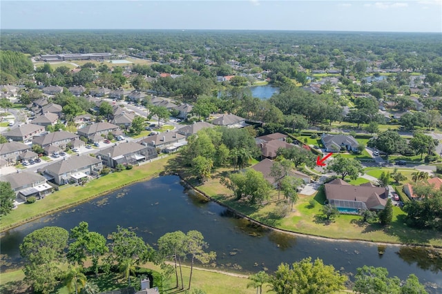drone / aerial view featuring a water view and a residential view