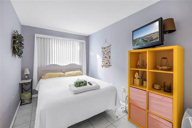 250 Medallion Blvd Unit H, Madeira Beach, FL 33708 - bedroom with baseboards and light tile patterned floors