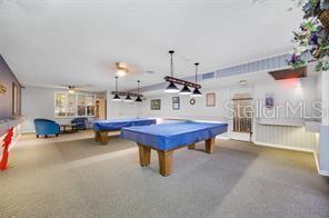 250 Medallion Blvd Unit H, Madeira Beach, FL 33708 - game room with pool table and carpet flooring