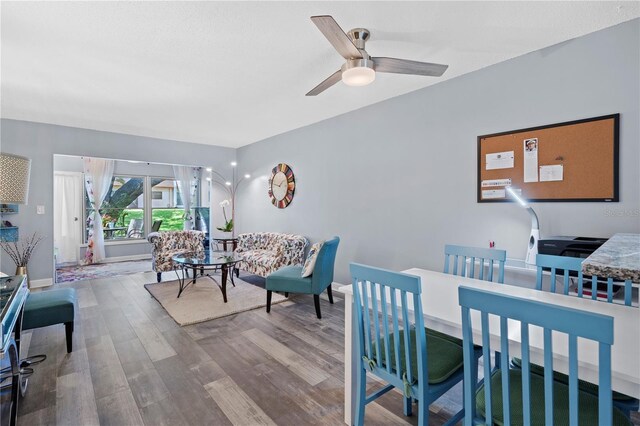 dining room with baseboards, ceiling fan, and wood finished floors