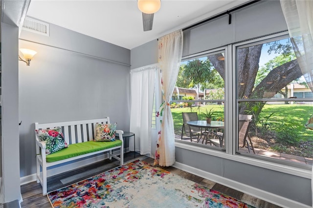 bedroom with visible vents, baseboards, and wood finished floors