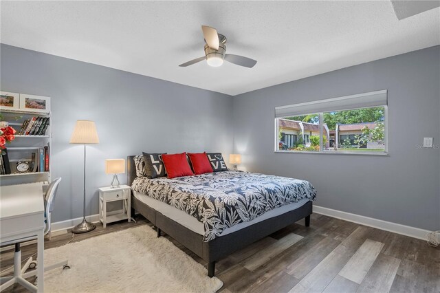 bedroom featuring a ceiling fan, baseboards, and wood finished floors