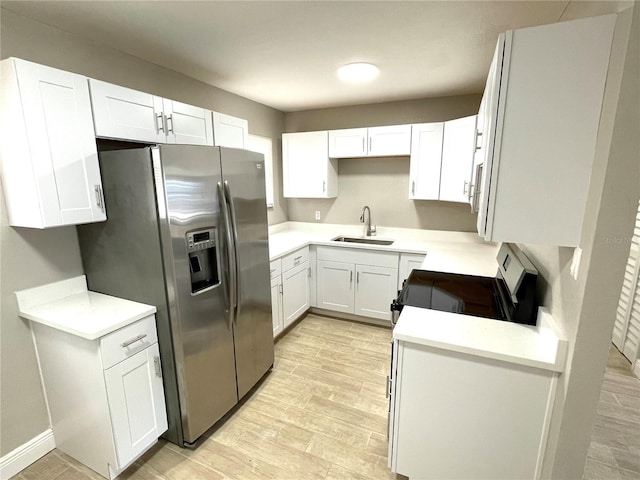 8310 Croton Ave, Tampa, FL 33619 - kitchen featuring stainless steel refrigerator with ice dispenser, a sink, white cabinetry, and range with electric stovetop