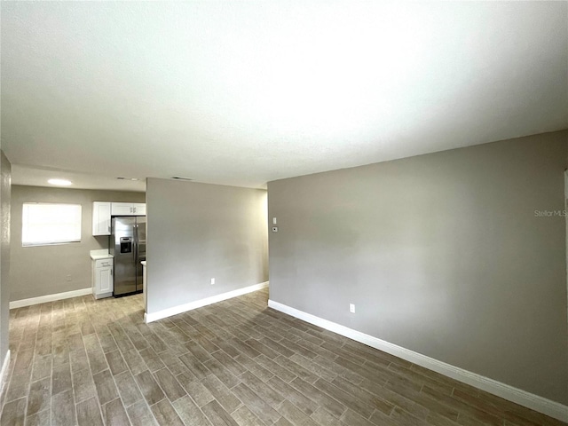 8310 Croton Ave, Tampa, FL 33619 - spare room featuring baseboards and wood finished floors