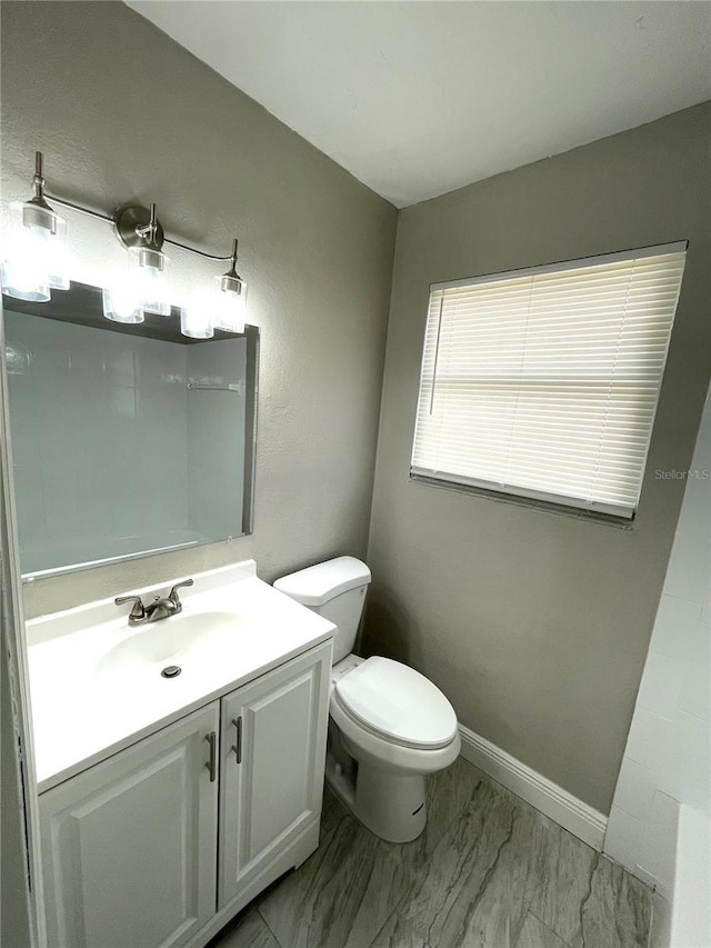 8310 Croton Ave, Tampa, FL 33619 - half bathroom with vanity, marble finish floor, and toilet