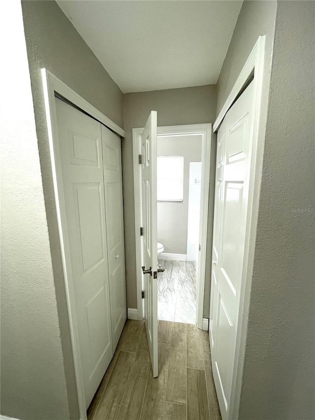 8310 Croton Ave, Tampa, FL 33619 - corridor with baseboards and wood finished floors