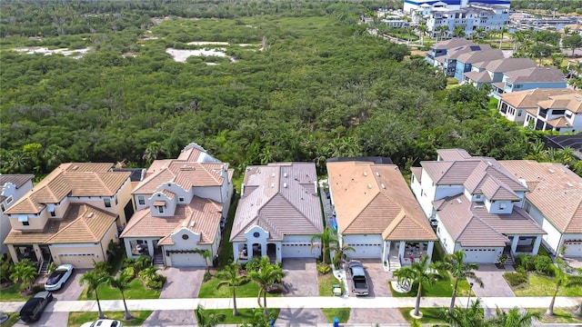 drone / aerial view featuring a forest view and a residential view
