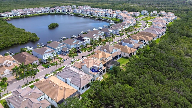 birds eye view of property featuring a residential view, a view of trees, and a water view