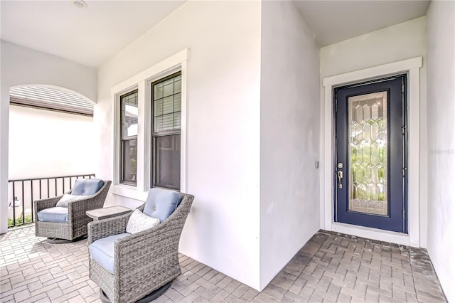 doorway to property featuring stucco siding