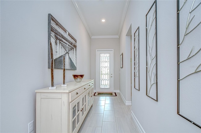 doorway featuring crown molding, baseboards, and recessed lighting