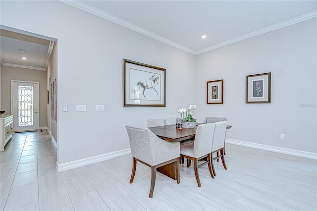 dining room featuring crown molding, baseboards, and recessed lighting