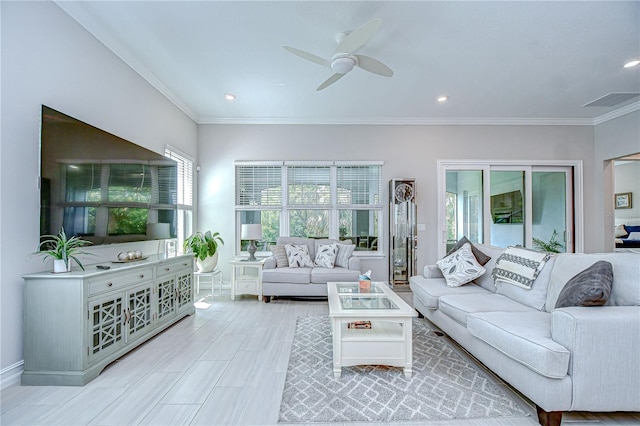 living area with recessed lighting, ceiling fan, ornamental molding, and baseboards