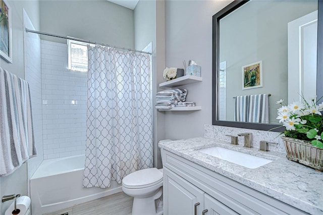 full bath with vanity, shower / bath combo with shower curtain, and toilet