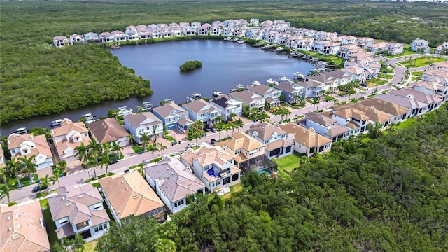 aerial view featuring a residential view, a water view, and a wooded view