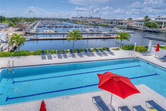 community pool featuring a water view and a patio area