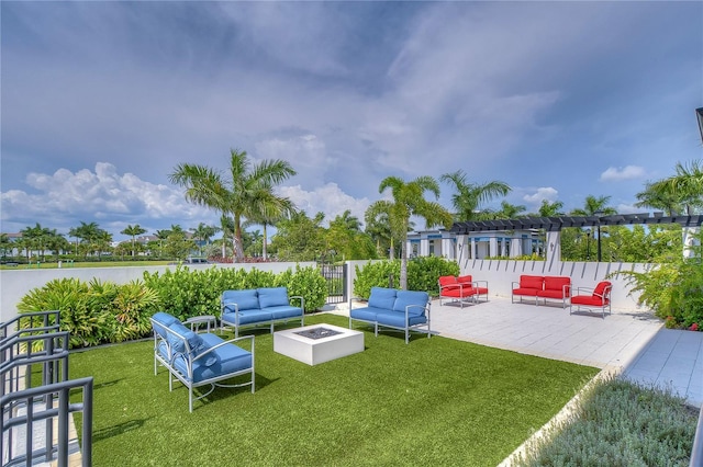 view of yard featuring a pergola, a patio area, and an outdoor living space with a fire pit