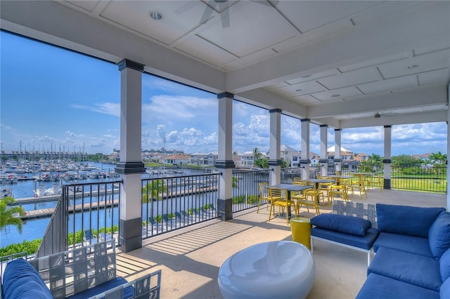 sunroom / solarium featuring a water view