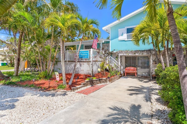 view of front of home with concrete driveway and stairway
