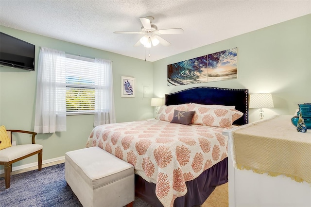 carpeted bedroom featuring a textured ceiling, baseboards, and ceiling fan