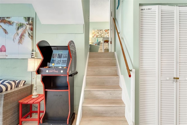 stairs featuring wood finished floors