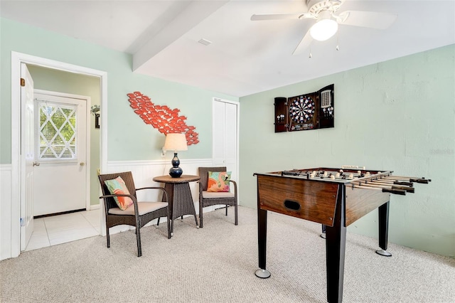 game room featuring carpet flooring, a ceiling fan, tile patterned floors, and a wainscoted wall