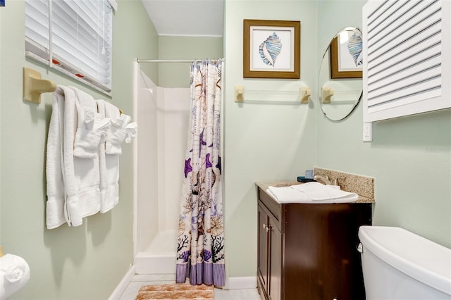 full bath featuring baseboards, vanity, toilet, and a shower stall