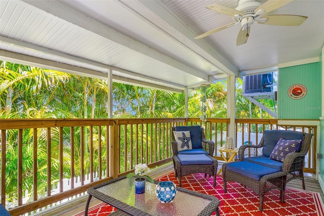 sunroom with beamed ceiling and ceiling fan