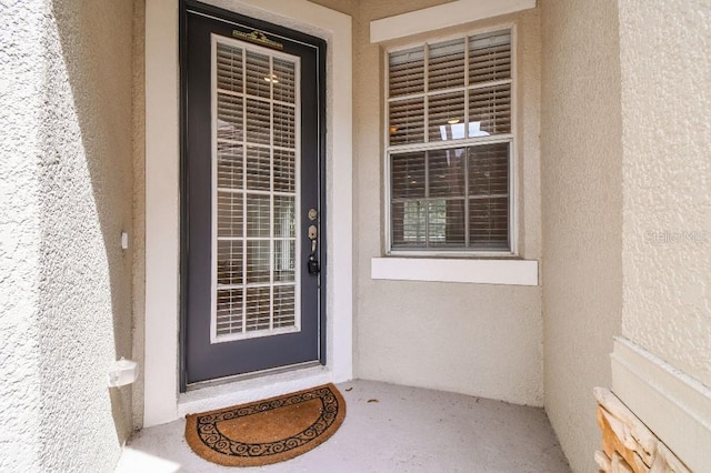 entrance to property with stucco siding