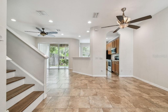 unfurnished living room featuring a ceiling fan, visible vents, and recessed lighting