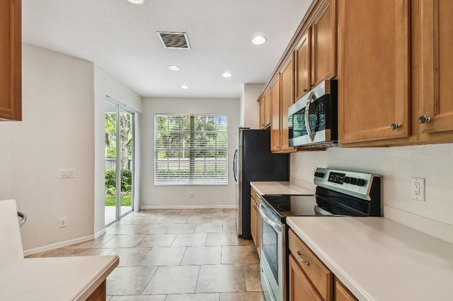 kitchen featuring brown cabinets, recessed lighting, appliances with stainless steel finishes, and light countertops