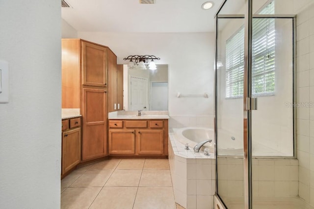 bathroom with a bath, visible vents, tile patterned flooring, a shower stall, and vanity