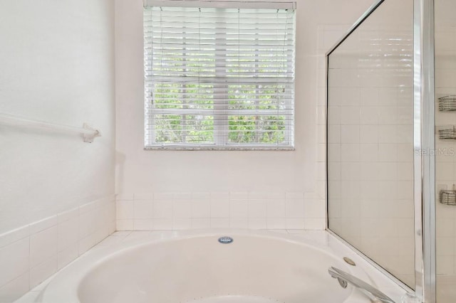full bath with a garden tub and a shower stall
