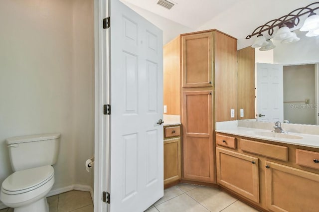 bathroom with vanity, toilet, tile patterned floors, baseboards, and visible vents