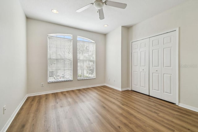 unfurnished bedroom with recessed lighting, baseboards, ceiling fan, and wood finished floors