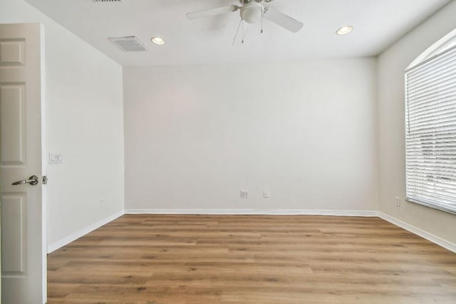 empty room with visible vents, recessed lighting, light wood-style floors, and a ceiling fan
