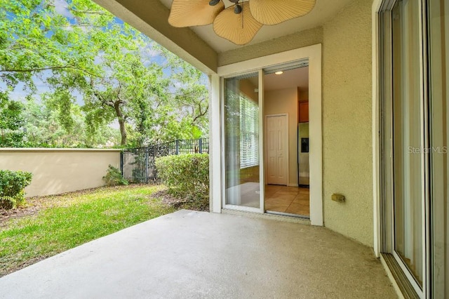 view of patio featuring ceiling fan and fence