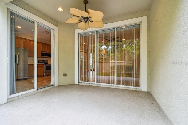 exterior space with ceiling fan, a patio area, and stucco siding