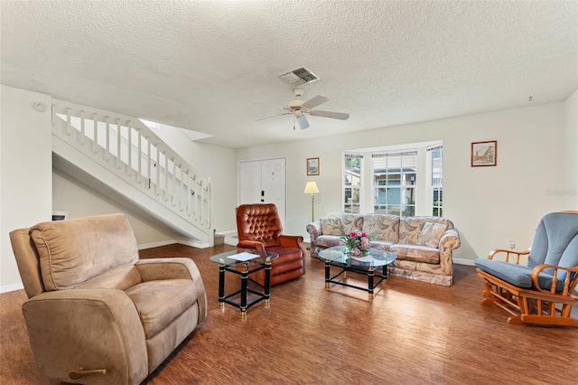 2373 Hounds Trl, Palm Harbor, FL 34683 - living area with a ceiling fan, a textured ceiling, visible vents, wood finished floors, and stairway