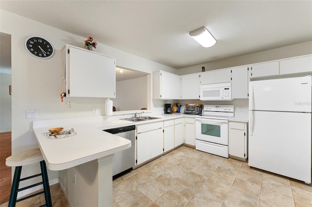 2373 Hounds Trl, Palm Harbor, FL 34683 - kitchen featuring a peninsula, white appliances, light countertops, white cabinets, and a sink
