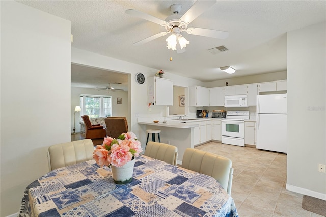 2373 Hounds Trl, Palm Harbor, FL 34683 - dining room with ceiling fan, a textured ceiling, visible vents, light tile patterned floors, and baseboards