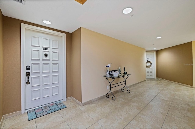 foyer entrance featuring baseboards, recessed lighting, and light tile patterned flooring