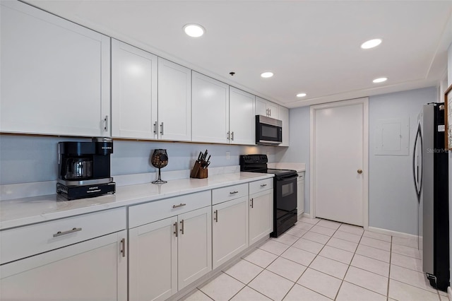 kitchen featuring recessed lighting, white cabinets, light stone counters, appliances with stainless steel finishes, and light tile patterned floors