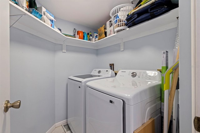 clothes washing area with laundry area and washer and clothes dryer