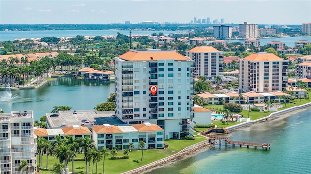 birds eye view of property with a view of city and a water view