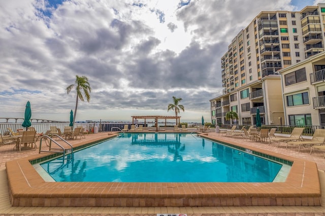 pool featuring fence and a patio area
