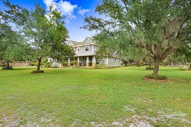 18929 Crescent Rd, Odessa, FL 33556 - view of green lawn featuring covered porch