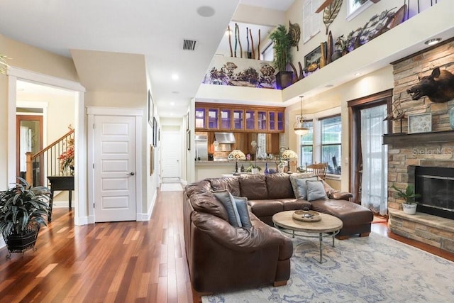 18929 Crescent Rd, Odessa, FL 33556 - living room with wood finished floors, a fireplace, stairs, baseboards, and a towering ceiling