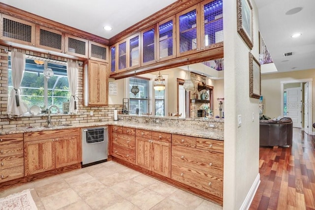 18929 Crescent Rd, Odessa, FL 33556 - kitchen featuring dishwasher, plenty of natural light, a sink, light stone counters, and recessed lighting