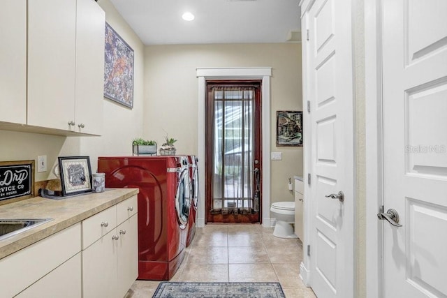 18929 Crescent Rd, Odessa, FL 33556 - laundry area featuring separate washer and dryer, cabinet space, light tile patterned floors, and recessed lighting