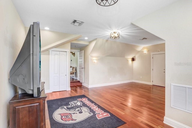 18929 Crescent Rd, Odessa, FL 33556 - foyer entrance with wood finished floors, baseboards, vaulted ceiling, and recessed lighting